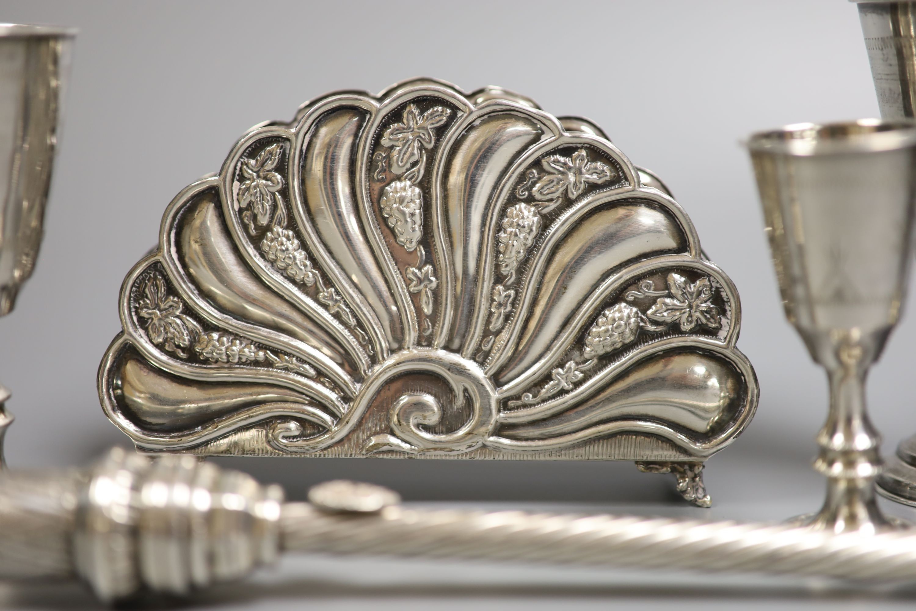 Four George V silver kiddush cups, largest 10.9cm, two other Judaic items, a 925 letter rack, silver napkin ring and Edwardian silver sugar basket.